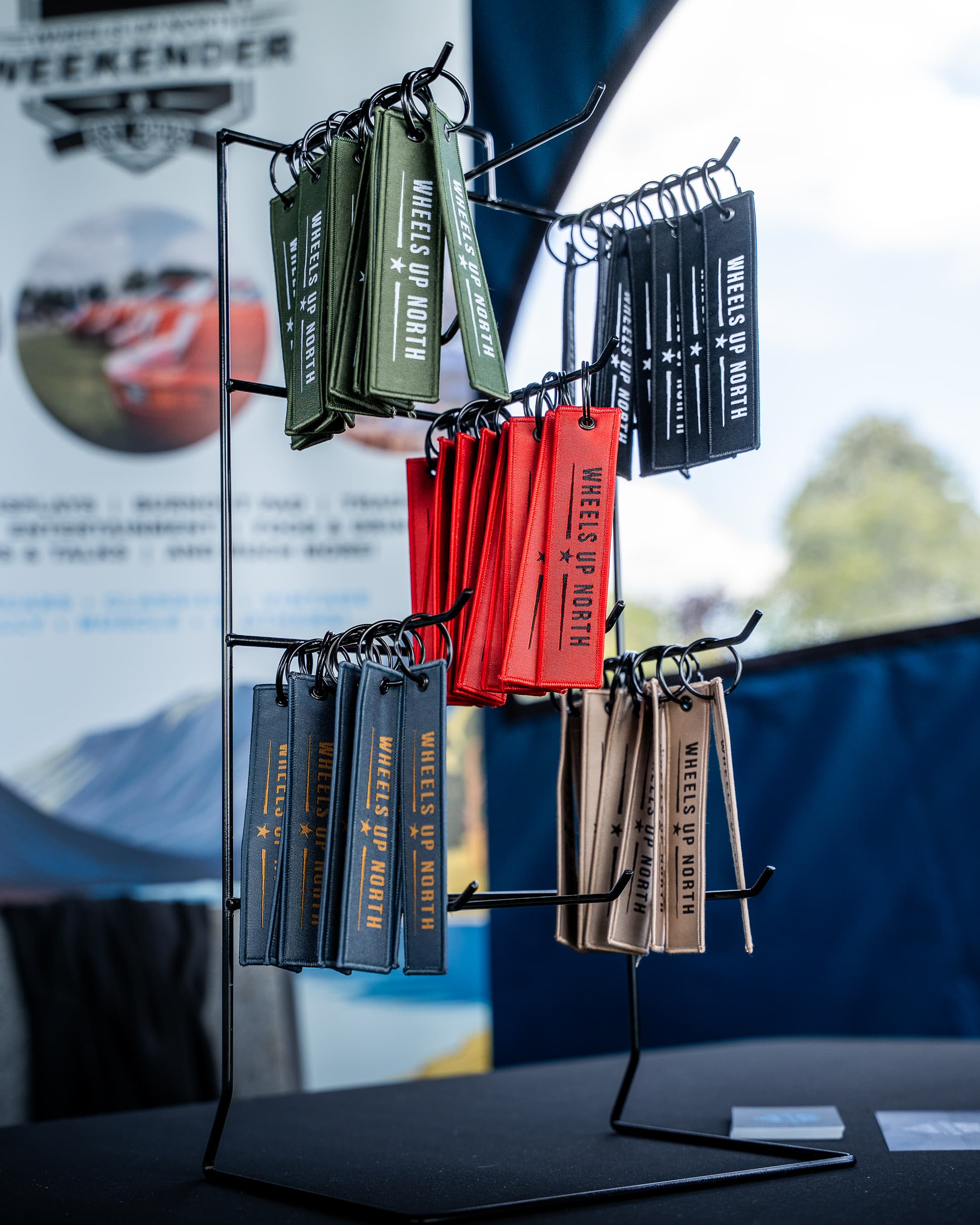 Wheels Up North Flight Tag - stand of wheels up north flight tags in every colour at an event