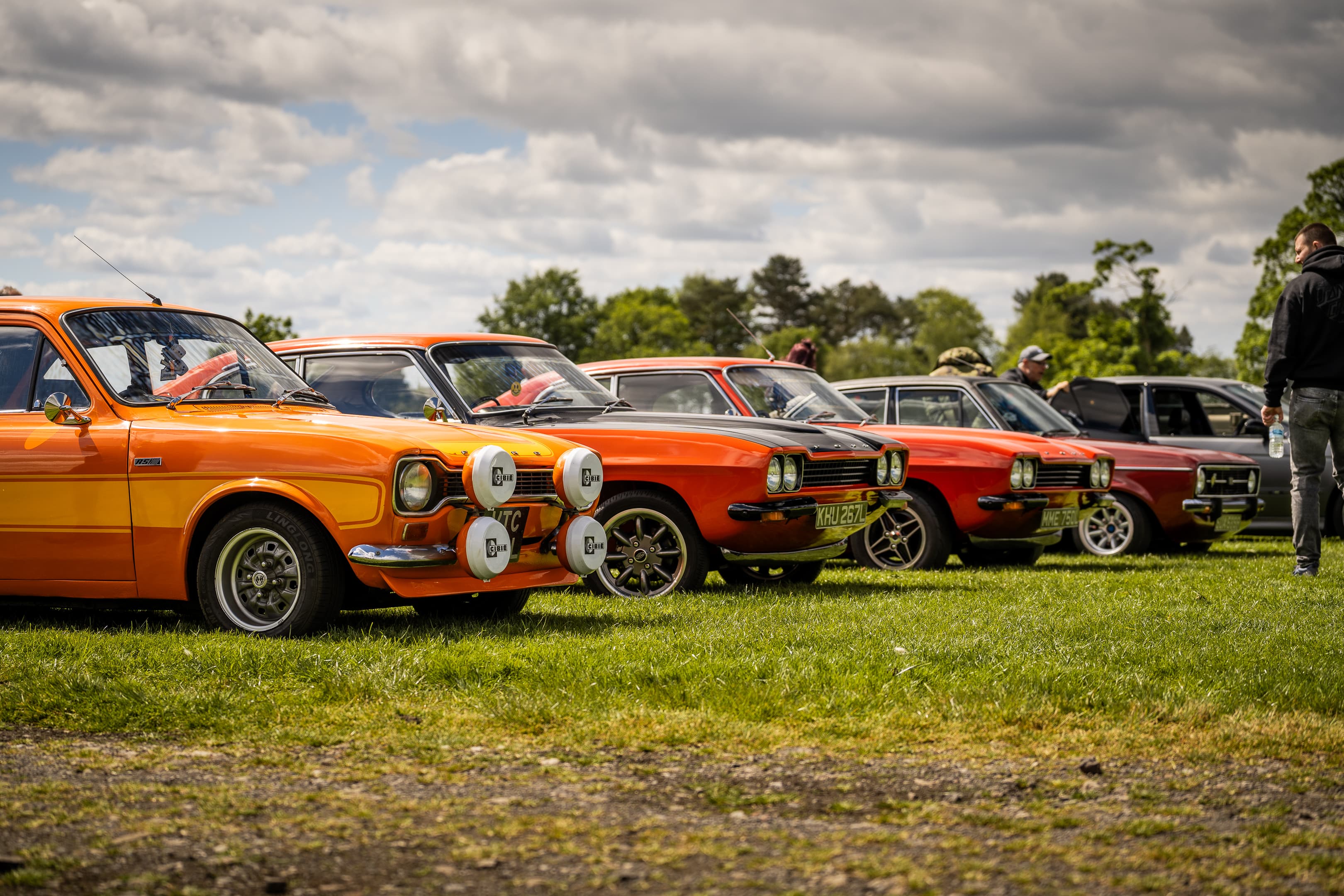Cars and visitors gathered at an outdoor Wheels Up North event