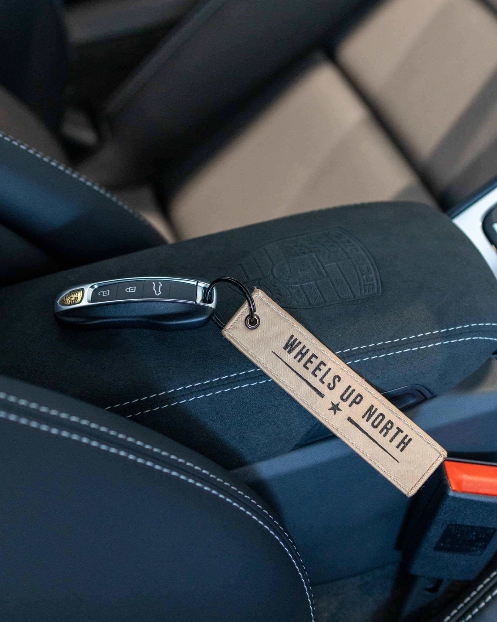 Wheels Up North Flight Tag - sand wheels up north flight tag on a car key resting on a leather seat