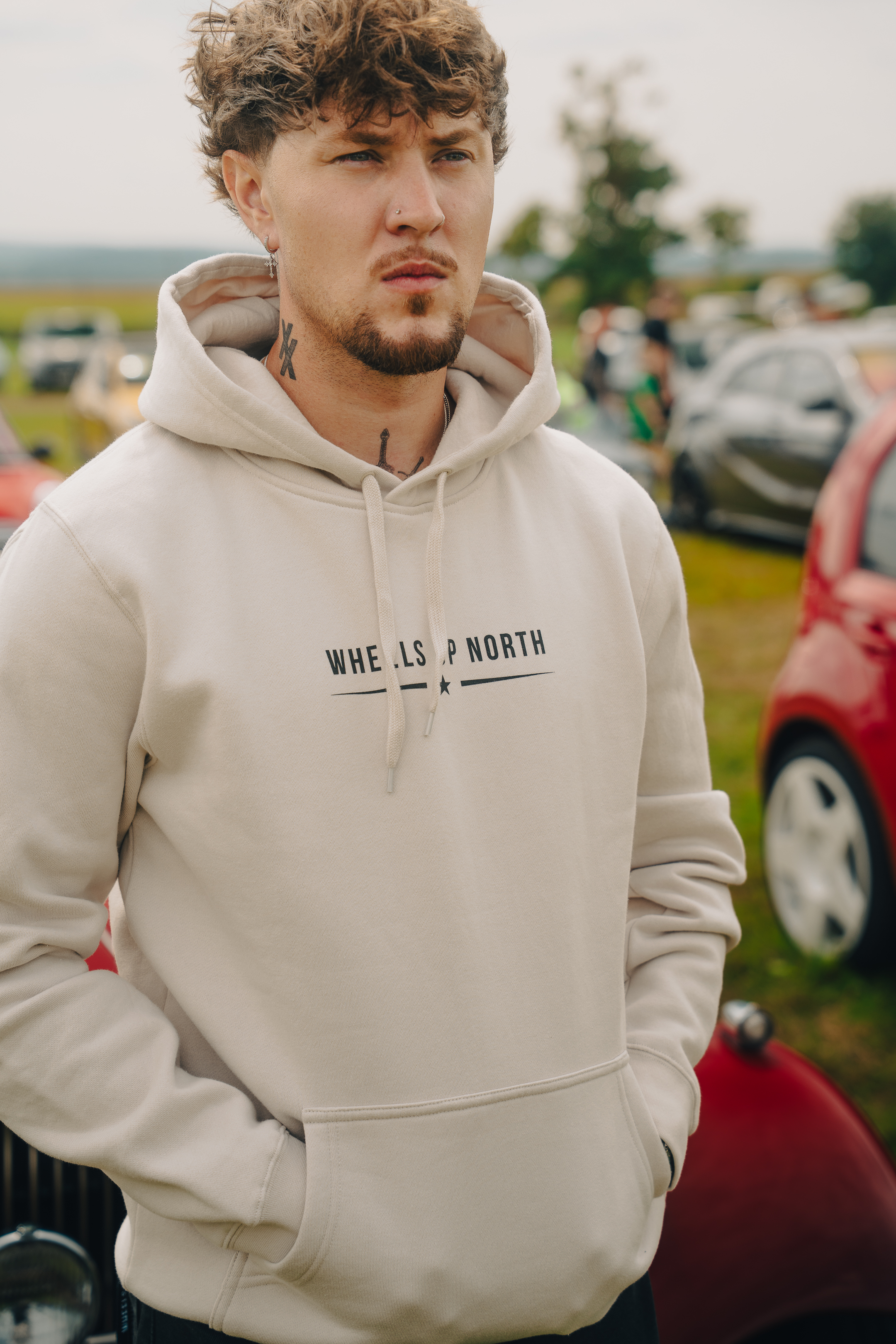 Grass 'Routes' Hoodie - Bone - man wearing the bone grass 'routes' hoodie with the wheels up north logo on the chest